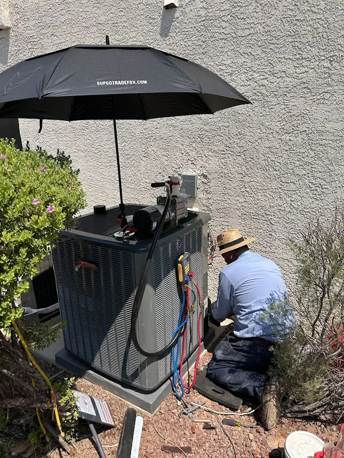 HVAC technician performing outdoor AC maintenance in Concord
