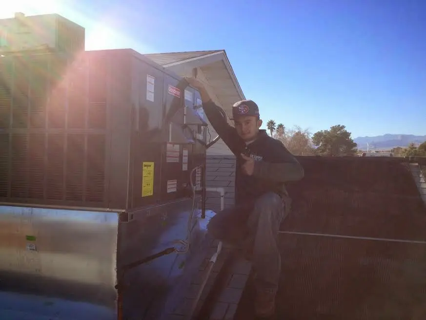 HVAC technician performing Heat Pump Repair on a rooftop unit in Concord